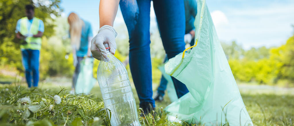 Jugendliche sammeln im Park Müll auf