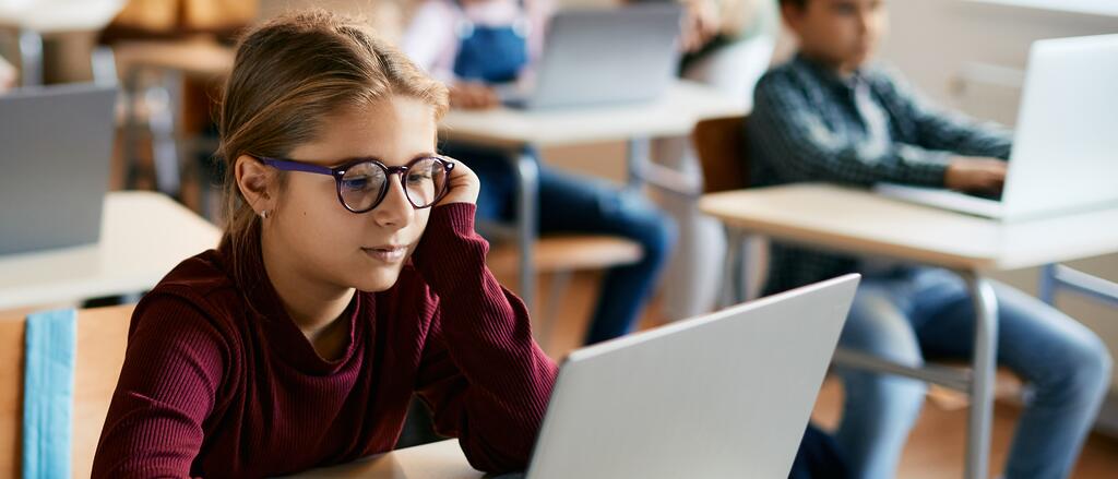 Schülerin sitzt an einem Laptop